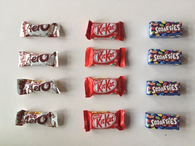 Halloween chocolate bars lined up for solving math problems. 