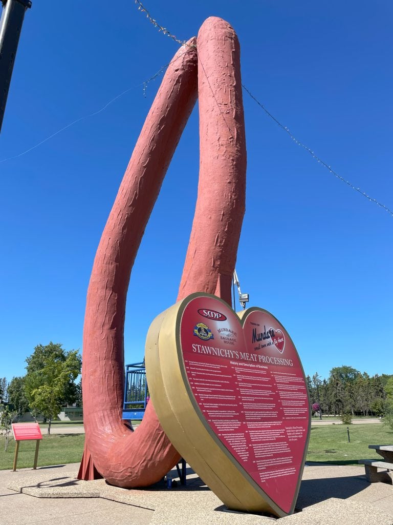 World's Largest Ukrainian Sausage in Mundare with the interpretive sign visible.