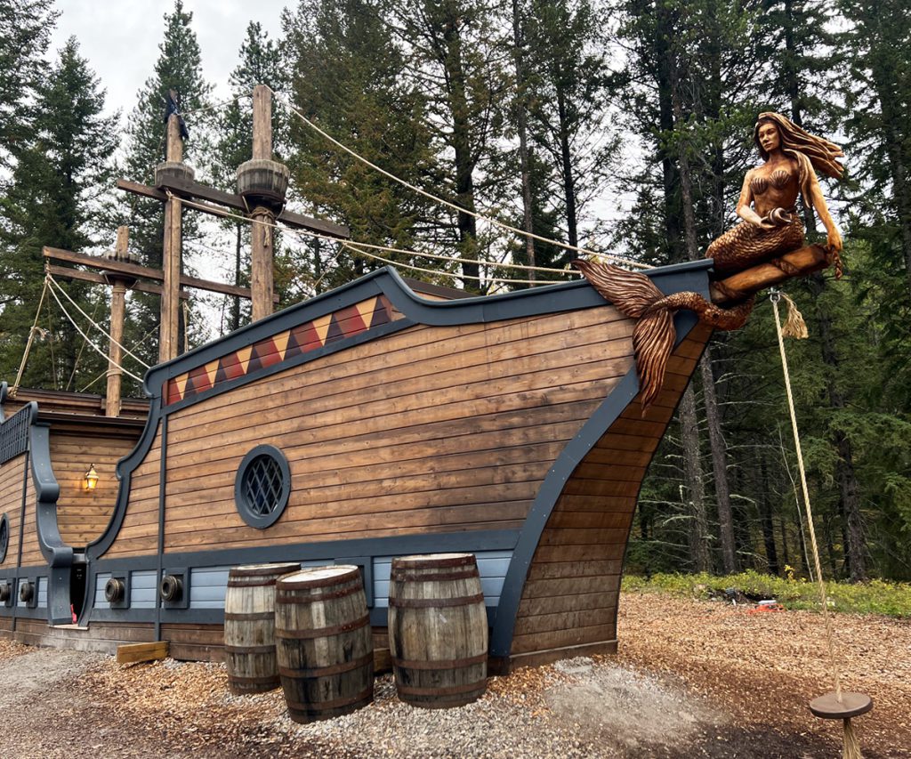 Exterior of Hook's Ship at Charmed Resorts in Crowsness Pass with the hand-carved mermaid at the prow