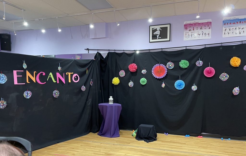Backdrop for the J'Adore Musical Theatre Encanto performance.