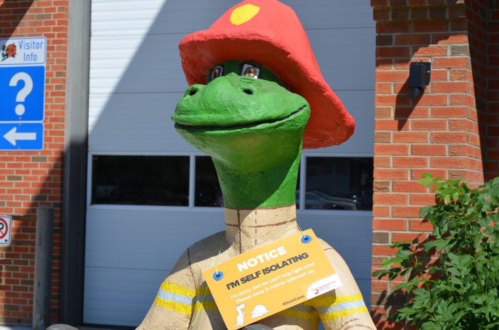 Drumheller Fire Station dinosaur statue with Isolating poster in 2020