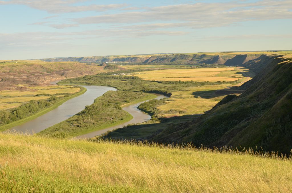 Looking south from the Orkney Viewpoint to see the hoodoo edge of the Red Deer River Valley with the Red Deer river snaking down the middle.