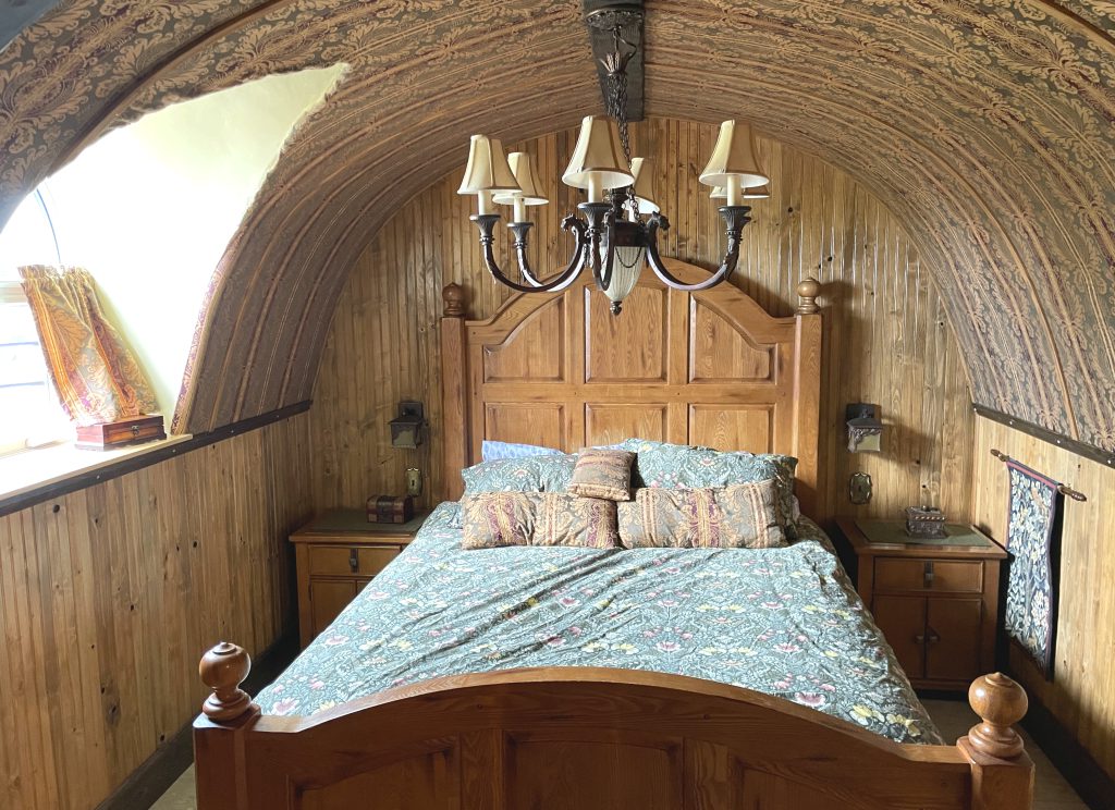The queen sized bed in The Burrow's bedroom