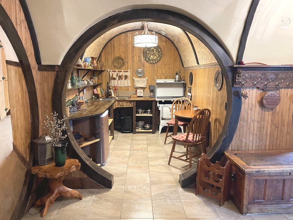 The view of the kitchen in The Burrow from the hallway with a beautiful round doorway