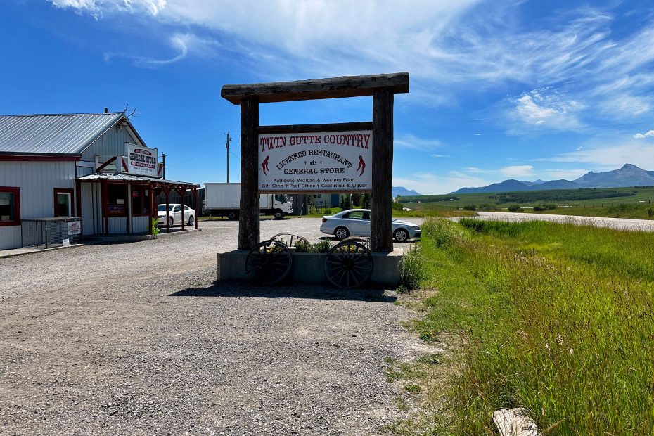 Twin Butte General Store exterior with mountains in the distance.